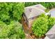 An aerial view showcasing the landscaped backyard and mature trees of a home in a lush neighborhood at 938 Canterbury Ln, Atlanta, GA 30324