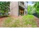 A view of the backyard featuring a walkout patio, lush greenery and a black fence at 938 Canterbury Ln, Atlanta, GA 30324