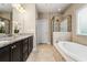 This bathroom offers dual sinks, granite countertops, a soaking tub, and a separate shower at 938 Canterbury Ln, Atlanta, GA 30324