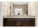 Bathroom vanity with dual sinks, dark wood cabinetry, and a large mirror at 938 Canterbury Ln, Atlanta, GA 30324