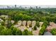 Aerial view of community, located near a wooded area, with a cityscape view in the distance at 938 Canterbury Ln, Atlanta, GA 30324