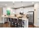 Well-lit kitchen featuring white cabinetry, stainless steel appliances, and a spacious island with bar stools at 938 Canterbury Ln, Atlanta, GA 30324