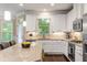 Bright kitchen featuring a center island, white cabinets, and stainless steel appliances at 938 Canterbury Ln, Atlanta, GA 30324