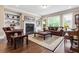 Bright living room featuring a fireplace, built-in bookshelves, large windows, and hardwood floors at 938 Canterbury Ln, Atlanta, GA 30324