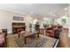 Inviting living room features a piano, leather seating, and an open floor plan leading to the kitchen and dining area at 938 Canterbury Ln, Atlanta, GA 30324