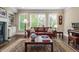 Bright living room featuring a fireplace, built-in bookshelves, large windows, and hardwood floors at 938 Canterbury Ln, Atlanta, GA 30324