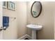 This powder room features a pedestal sink, oval mirror, and neutral wall color at 938 Canterbury Ln, Atlanta, GA 30324