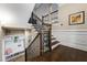 Staircase featuring hardwood steps and decorative iron spindles at 938 Canterbury Ln, Atlanta, GA 30324