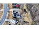 Aerial view showing the deck, firepit, long driveway, and landscaping at 1683 Wheatstone Dr, Grayson, GA 30017