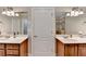 Bright bathroom with double sinks, framed mirrors and modern lighting fixtures at 1683 Wheatstone Dr, Grayson, GA 30017