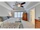 Spacious main bedroom featuring a trey ceiling, ceiling fan and a large dresser at 1683 Wheatstone Dr, Grayson, GA 30017