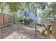 Secluded backyard with lush greenery, mature trees, and a rustic wooden fence at 259 14Th Ne St # 104, Atlanta, GA 30309