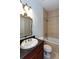 Elegant bathroom features an ornate mirror, tiled shower and bath with stylish fixtures at 259 14Th Ne St # 104, Atlanta, GA 30309