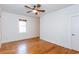 Bedroom featuring hardwood flooring, white trim, window with wood blinds, and ceiling fan at 259 14Th Ne St # 104, Atlanta, GA 30309