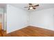 A bedroom with hardwood floors, a ceiling fan, and access to other rooms in the house at 259 14Th Ne St # 104, Atlanta, GA 30309