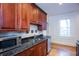 Stylish kitchen showcases dark wood cabinets and granite counters creating a warm and sophisticated space at 259 14Th Ne St # 104, Atlanta, GA 30309