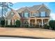 Inviting two-story home with a stone and shingle facade and a well-manicured front lawn at 3309 Nw Past Nw Pl, Kennesaw, GA 30152