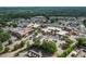 Expansive aerial view of the property with parking lots, stores, and surrounding trees at 6792 Hunters Trace Cir, Atlanta, GA 30328