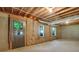 Unfinished basement with exposed ceiling, concrete floors, and natural light at 6792 Hunters Trace Cir, Atlanta, GA 30328