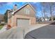 Side view of home, showing the large gray garage door and paved driveway at 6792 Hunters Trace Cir, Atlanta, GA 30328