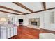 Cozy living room with stone fireplace, wood beam ceiling, and built-in bookshelves at 6792 Hunters Trace Cir, Atlanta, GA 30328