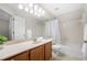 Bathroom features a large vanity, and a tub with shower at 1219 Waterville Ct, Alpharetta, GA 30022