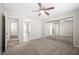 Bright bedroom featuring neutral tones, carpeted floor, ceiling fan and closet with mirrored doors at 1219 Waterville Ct, Alpharetta, GA 30022