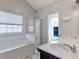 Bright bathroom featuring a soaking tub, separate glass shower, and double vanity at 1348 Rolling Stream Way, Lawrenceville, GA 30043