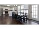 Dining area with hardwood floors, access to the backyard, and a view of the white kitchen cabinets at 1348 Rolling Stream Way, Lawrenceville, GA 30043