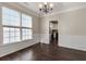 Bright dining room featuring hardwood floors, modern lighting, and a view of the kitchen at 1348 Rolling Stream Way, Lawrenceville, GA 30043