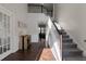 A large, light-filled foyer that showcases hardwood floors, a staircase, and paneled walls at 1348 Rolling Stream Way, Lawrenceville, GA 30043