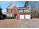 Charming two-story home featuring brick and siding, a two-car garage, and a well-manicured front lawn at 1348 Rolling Stream Way, Lawrenceville, GA 30043