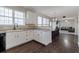 Well-lit kitchen with white cabinets and stainless steel appliances open to the dining and living area at 1348 Rolling Stream Way, Lawrenceville, GA 30043