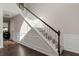 A staircase with white trim and dark wood floors leads to the upper level of the home at 1348 Rolling Stream Way, Lawrenceville, GA 30043