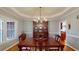 Traditional dining room with chandelier, hardwood floors, and a large window at 1510 Mount Mckinley Dr, Grayson, GA 30017