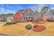 Beautiful two-story brick home with covered front porch, trimmed shrubbery, and landscaped yard at 1510 Mount Mckinley Dr, Grayson, GA 30017