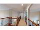 Upper hallway with carpet and decorative railing at 1510 Mount Mckinley Dr, Grayson, GA 30017