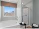 Bright bathroom featuring a soaking tub, large window, and a separate glass shower at 305 Heavenly Hollow Pl, Mcdonough, GA 30253