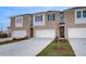 Beautiful townhome with brick facade, a white garage door, and well-manicured lawn at 305 Heavenly Hollow Pl, Mcdonough, GA 30253