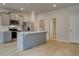 Modern kitchen featuring stainless steel appliances, light gray cabinets, and a quartz countertop island at 305 Heavenly Hollow Pl, Mcdonough, GA 30253