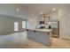 Kitchen with stainless steel appliances, island and granite countertops that opens up to living room at 305 Heavenly Hollow Pl, Mcdonough, GA 30253