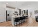 Modern kitchen featuring a large island with seating, stainless steel appliances, and sleek, white cabinetry at 305 Heavenly Hollow Pl, Mcdonough, GA 30253