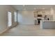 Open-concept space features a kitchen with gray cabinetry and stainless steel appliances, and modern flooring at 305 Heavenly Hollow Pl, Mcdonough, GA 30253