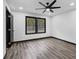 Bedroom with luxury vinyl plank flooring, black trim windows and a ceiling fan at 3661 W Potomac Dr, East Point, GA 30344