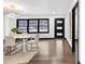 Elegant dining room featuring modern lighting, a dining table with seating, and dark hardwood floors at 3661 W Potomac Dr, East Point, GA 30344