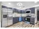 Modern kitchen with stainless steel appliances, white subway tile, and shaker style navy cabinets at 3661 W Potomac Dr, East Point, GA 30344