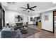 Open concept living room featuring stylish decor, modern ceiling fan, and an eat in kitchen at 3661 W Potomac Dr, East Point, GA 30344