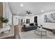 Open-concept living room with dark hardwood floors and seamless flow to the kitchen area at 3661 W Potomac Dr, East Point, GA 30344