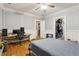 Comfortable bedroom featuring hardwood floors, gray walls with white trim, and a desk at 946 Highland Ne Vw, Atlanta, GA 30306