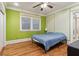 Sunny bedroom featuring hardwood floors and green painted walls at 946 Highland Ne Vw, Atlanta, GA 30306